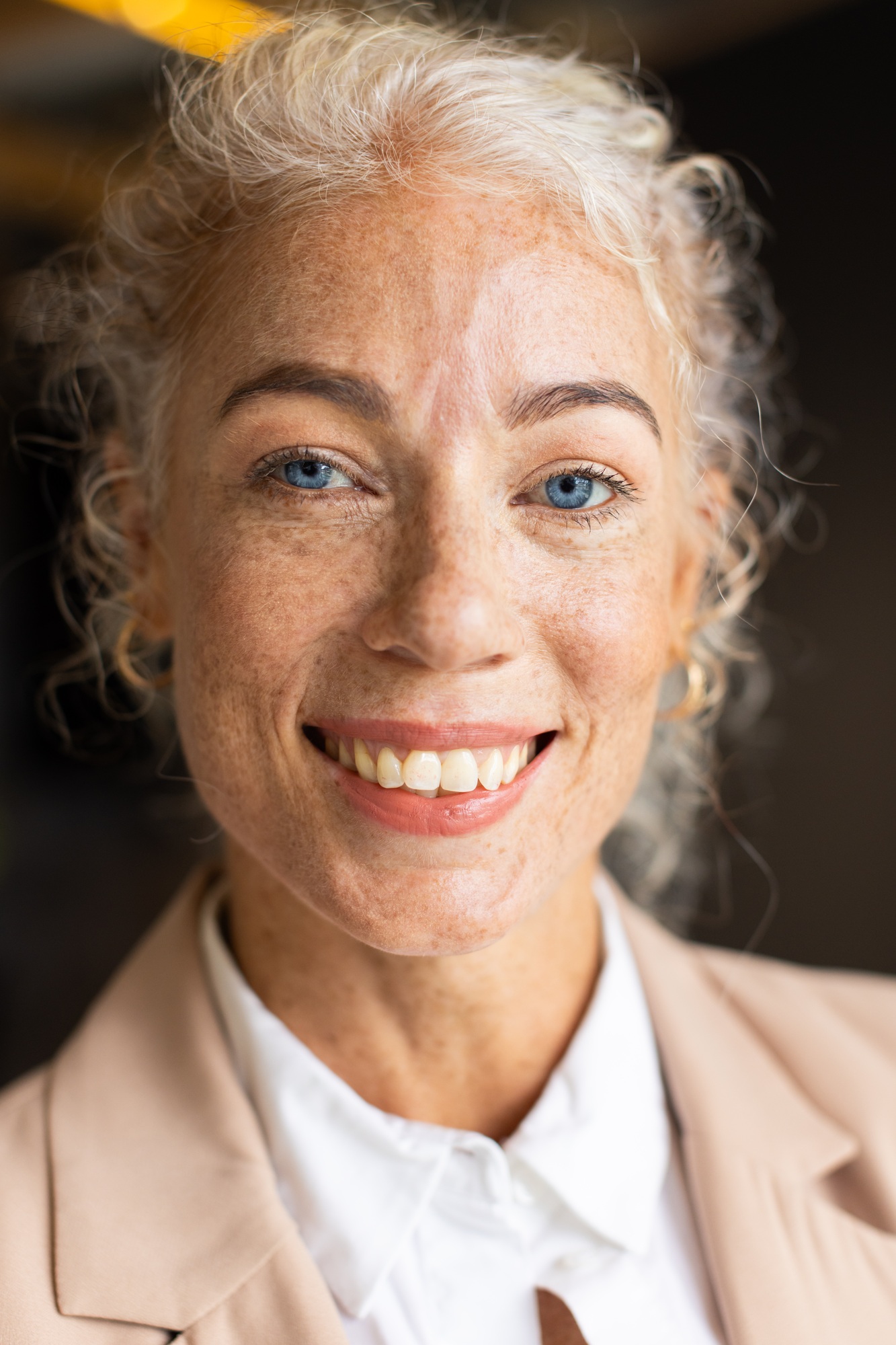 Smiling woman in business attire posing confidently for professional headshot